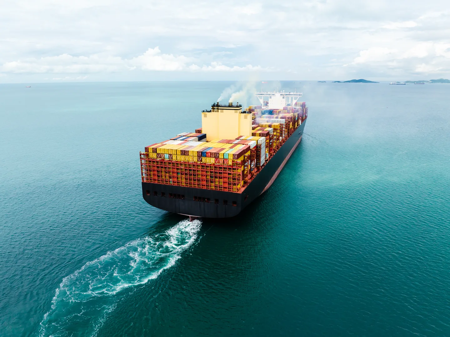 A container ship carrying international cargo across the sea
